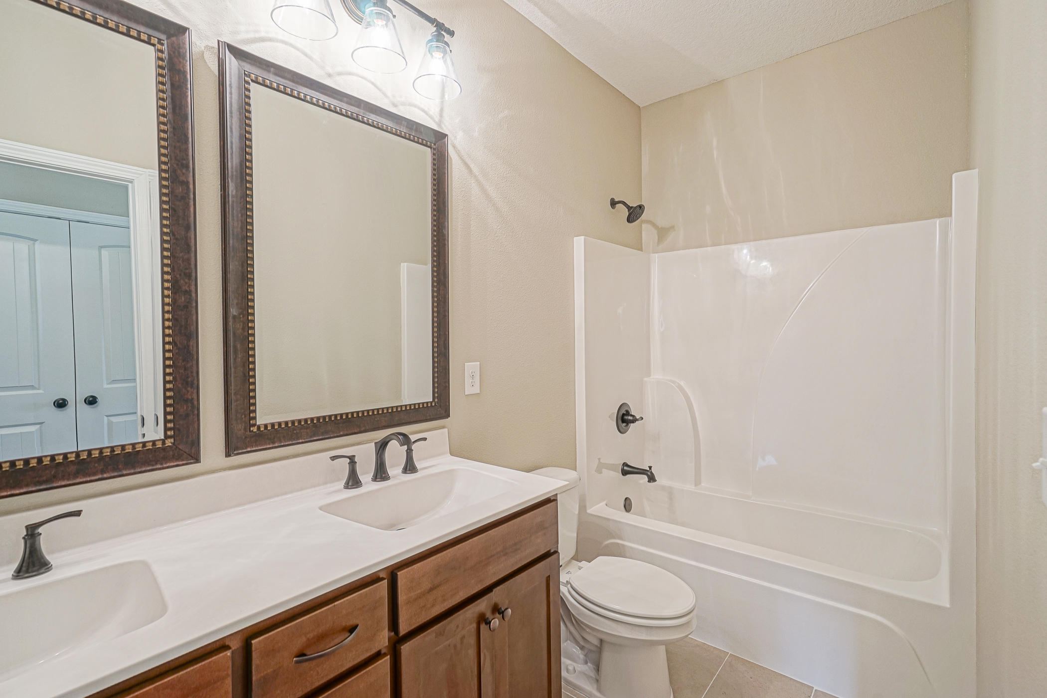 6193 Timberland Ridge Drive Crestview, FL 32539 - Photo 28 of 37 a bathroom with a granite countertop sink a toilet and a bathtub