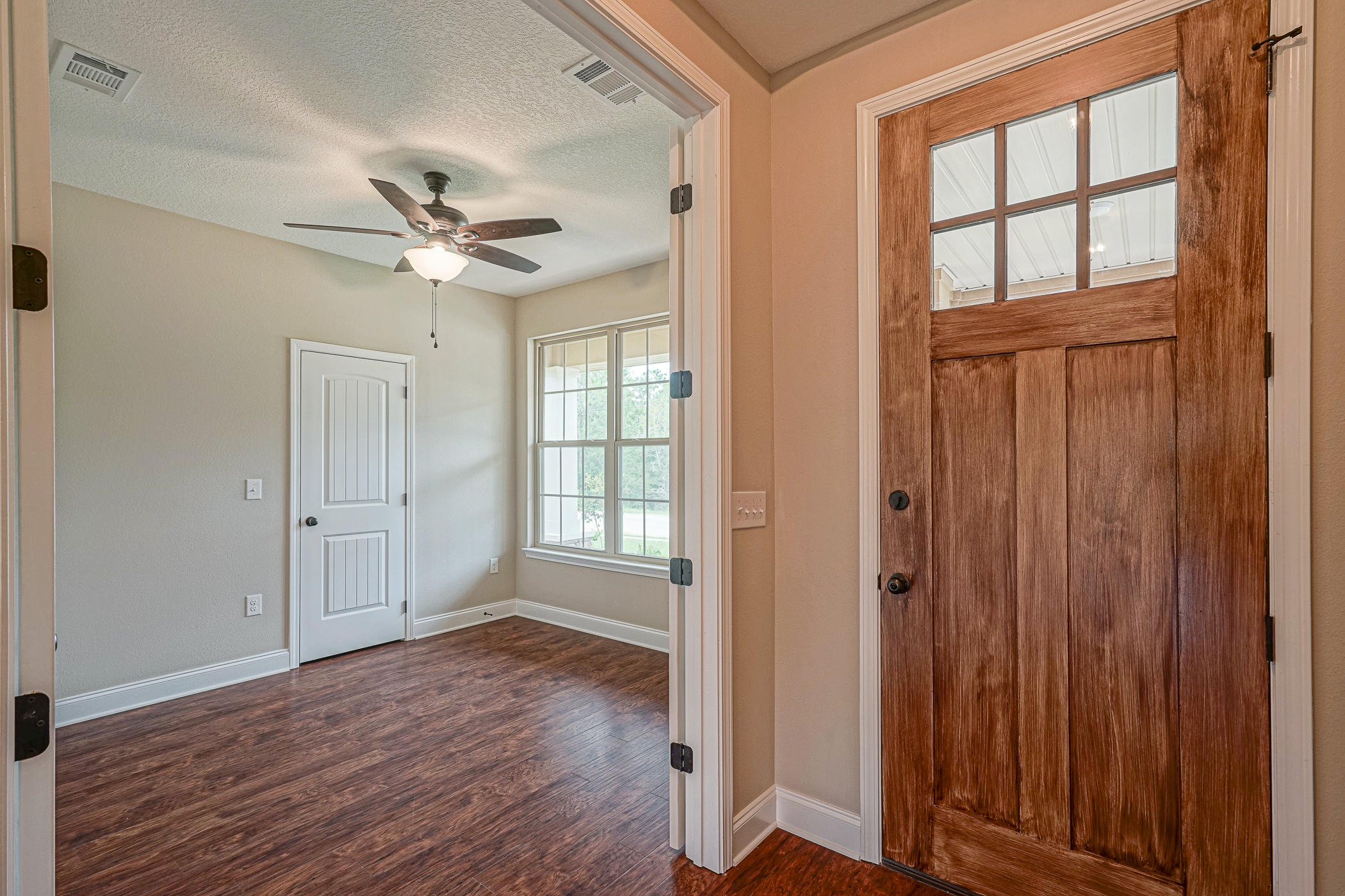 6193 Timberland Ridge Drive Crestview, FL 32539 - Photo 5 of 37 wooden floor in an empty room with a window