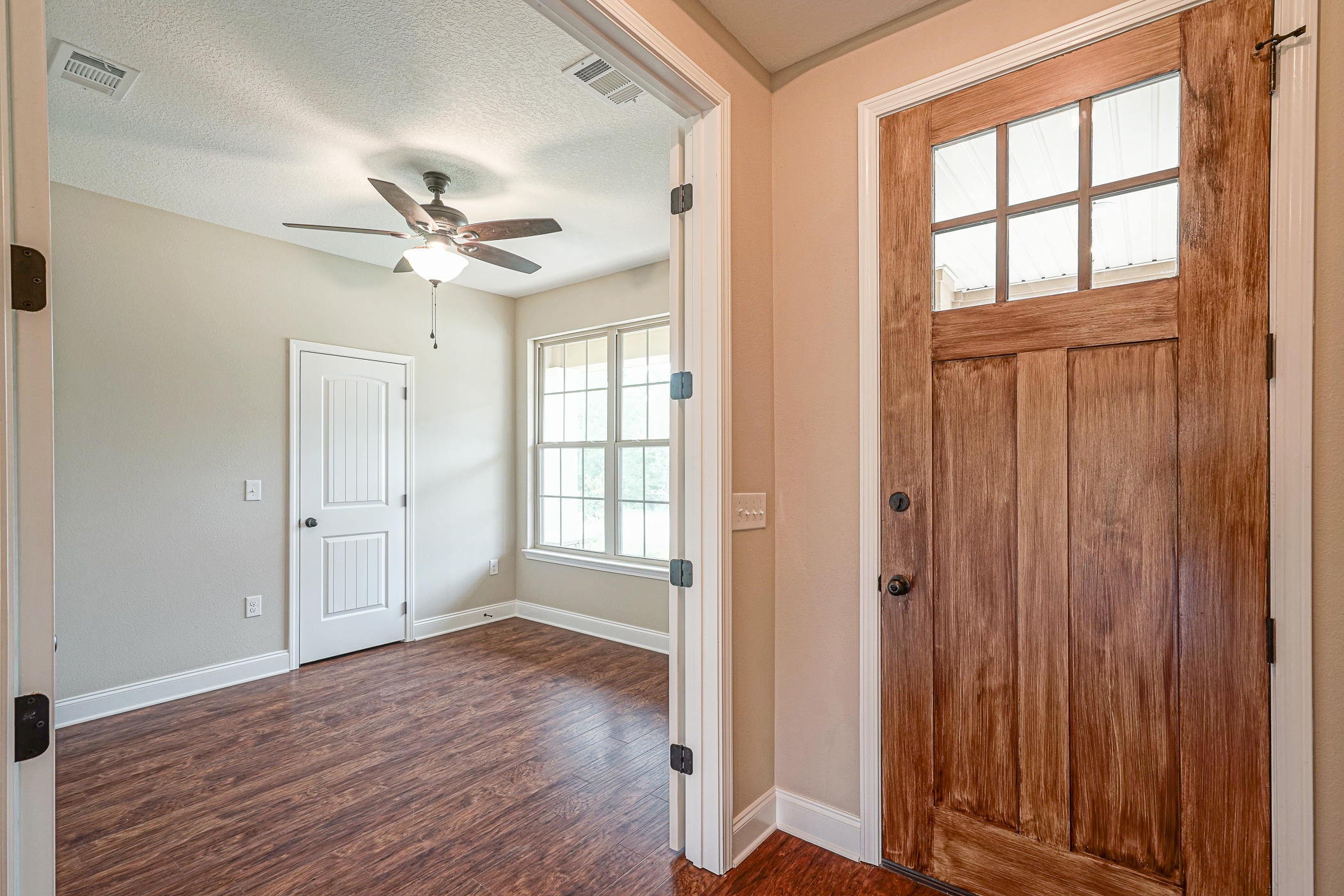 6193 Timberland Ridge Drive Crestview, FL 32539 - Photo 6 of 37 wooden floor in an empty room with a window