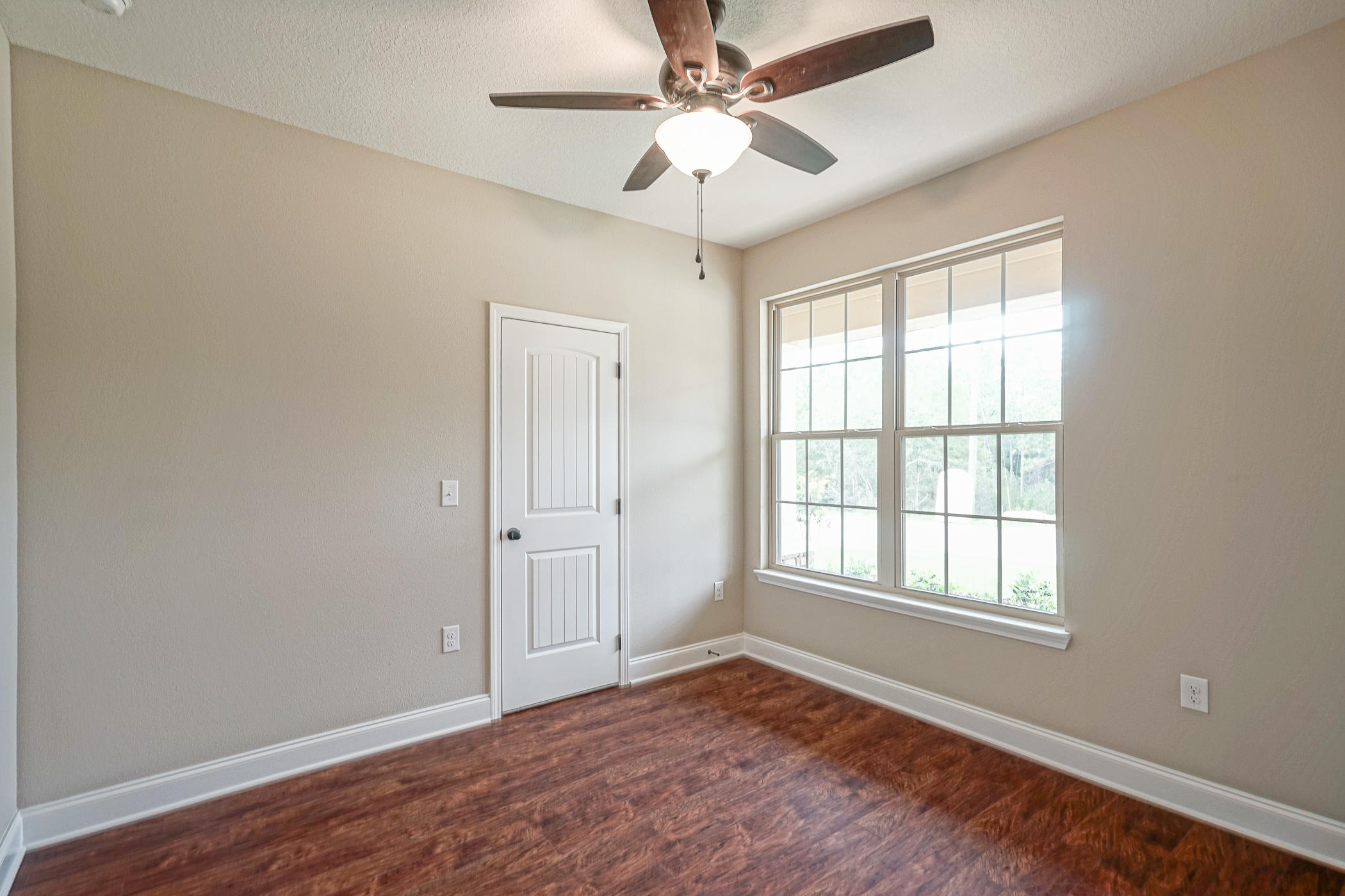 6193 Timberland Ridge Drive Crestview, FL 32539 - Photo 7 of 37 a view of an empty room with wooden floor and a window