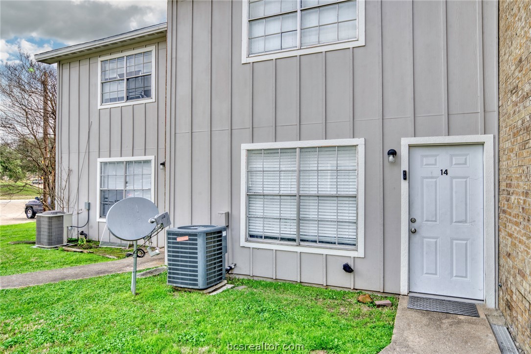 1908 Barak Lane, Unit 14 Bryan, TX 77802 - Photo 2 of 10 Property entrance featuring central AC and a lawn