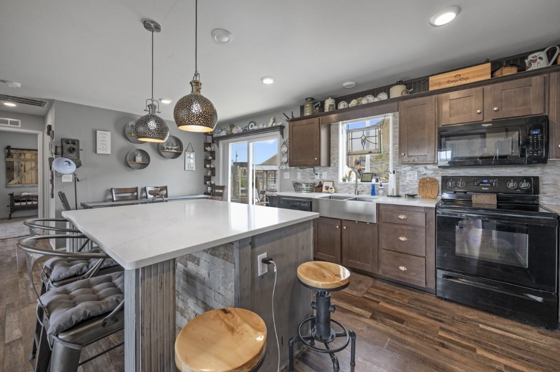 1792 10 Road Mack, CO 81525 - Photo 3 of 35 a kitchen with a table a stove and a wooden cabinets