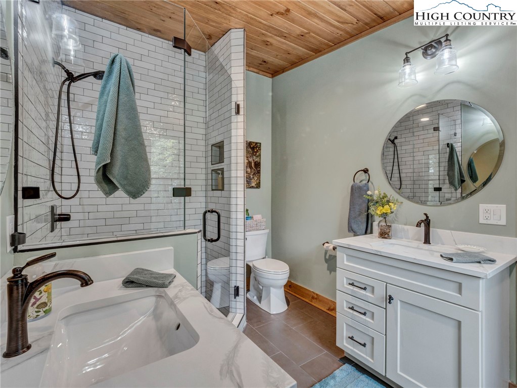 137 Green Cliffs Road Sugar Mountain, NC 28604 - Photo 40 of 48 a bathroom with a sink mirror and toilet