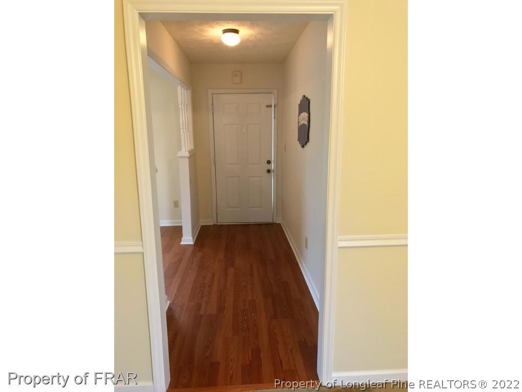 42 Woodwind Drive Spring Lake, NC 28390 - Photo 2 of 10 a view of a hallway with wooden floor