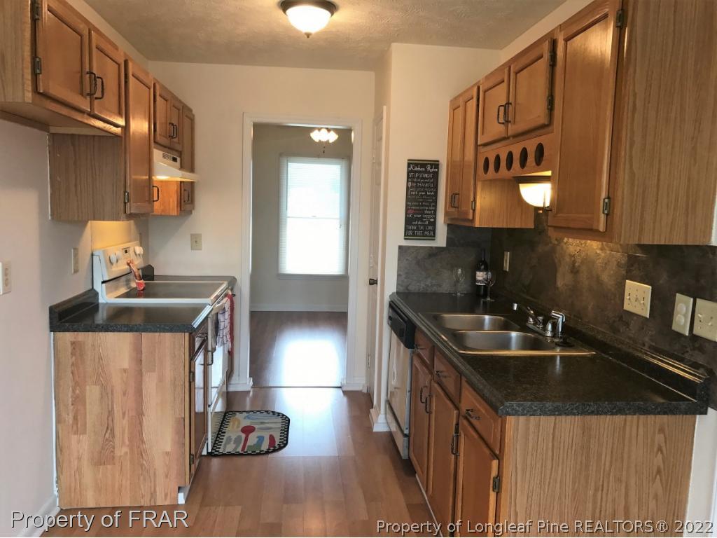 42 Woodwind Drive Spring Lake, NC 28390 - Photo 5 of 10 a kitchen that has a sink and a stove