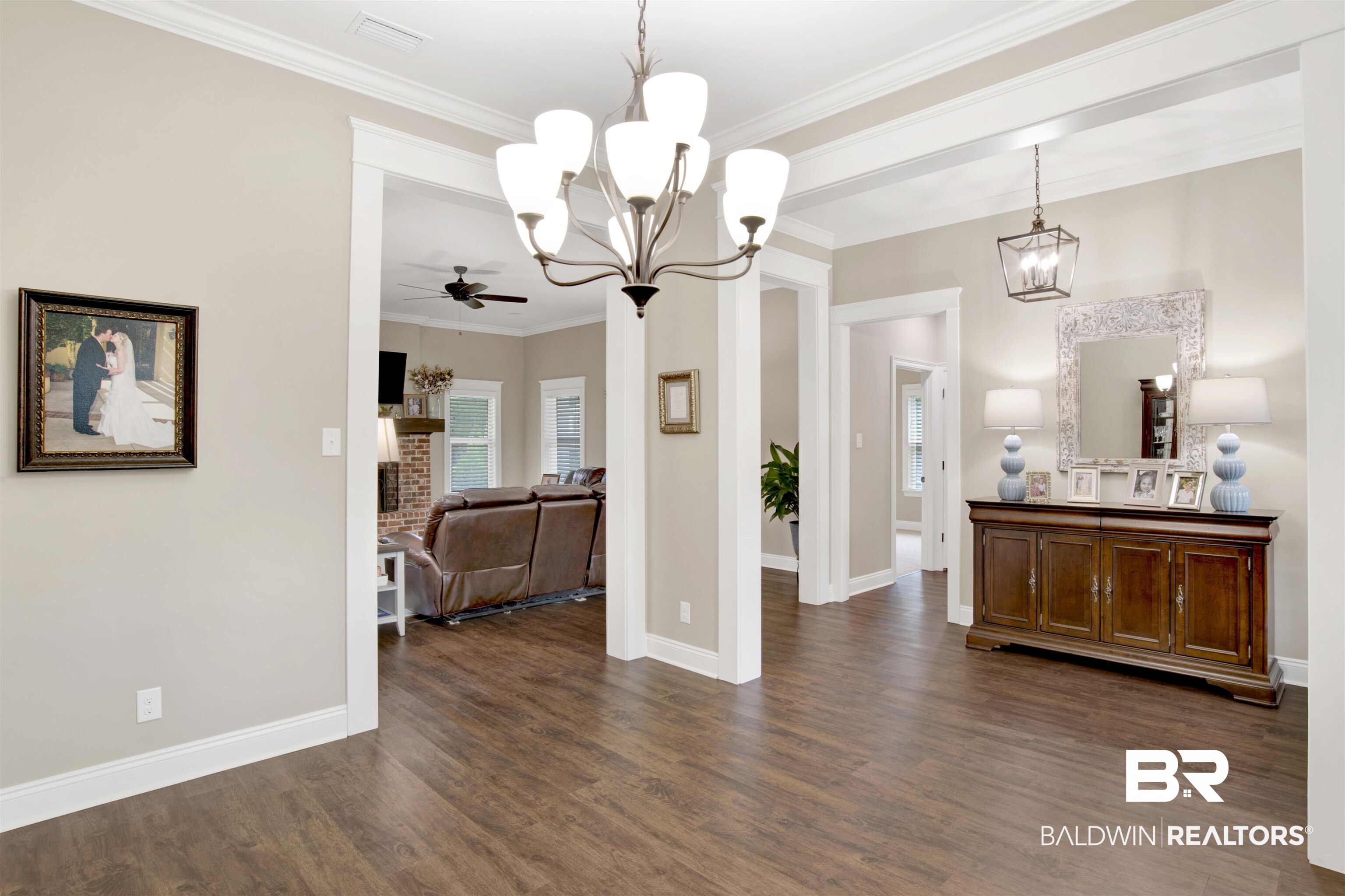 2440 Johnson Road West Mobile, AL 36695 - Photo 20 of 40 Dining area with ceiling fan, dark hardwood / wood-style floors, crown molding, and a brick fireplace