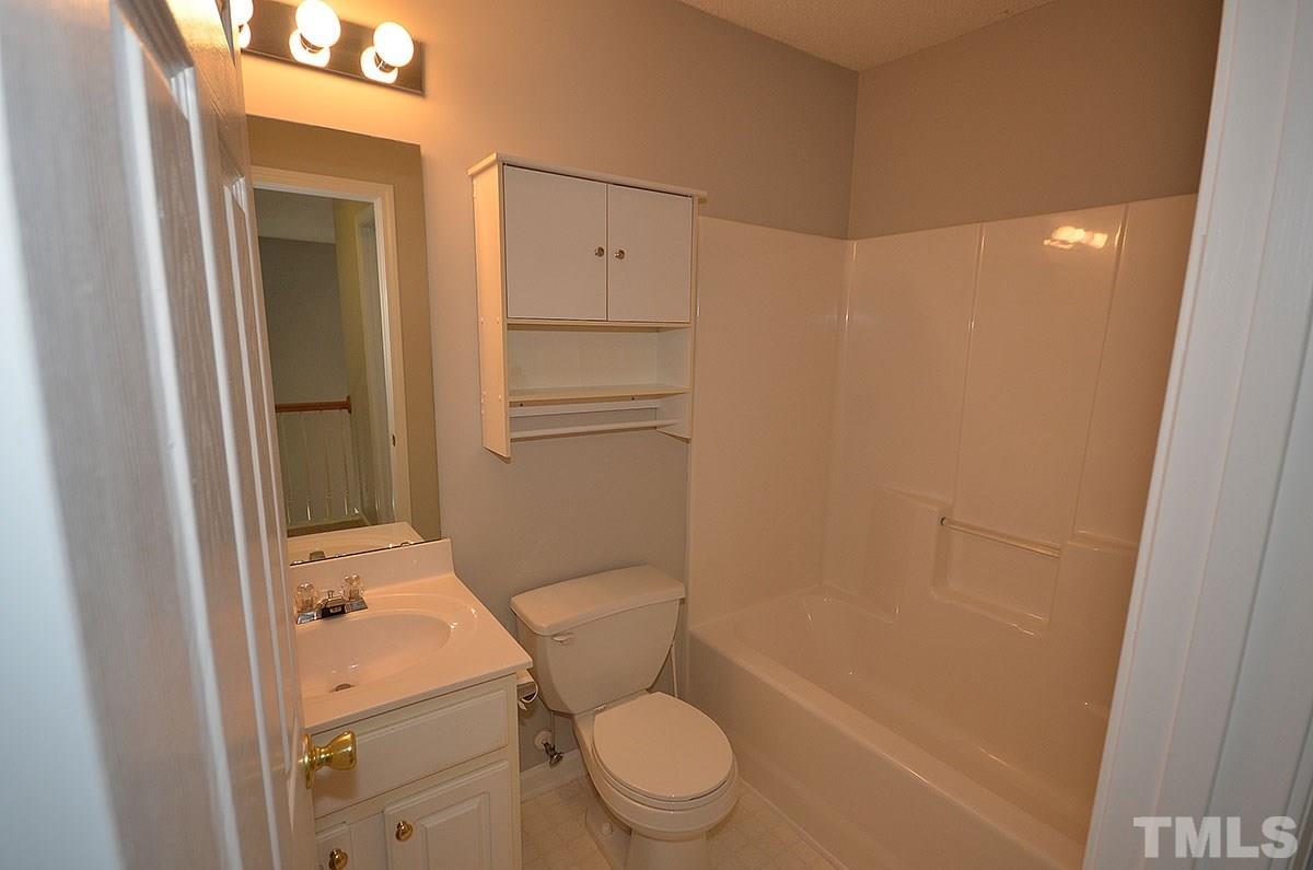 9100 Shallcross Way Raleigh, NC 27617 - Photo 22 of 29 a bathroom with a granite countertop sink toilet and shower