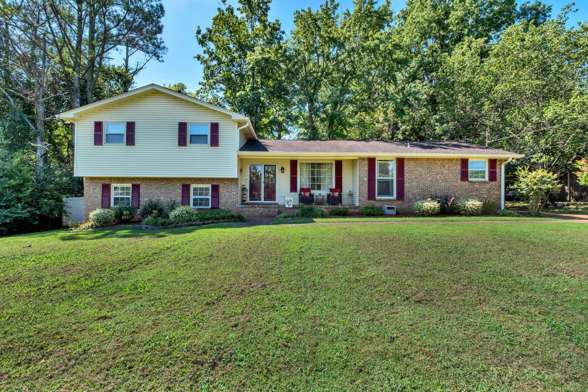 a front view of house with yard and green space