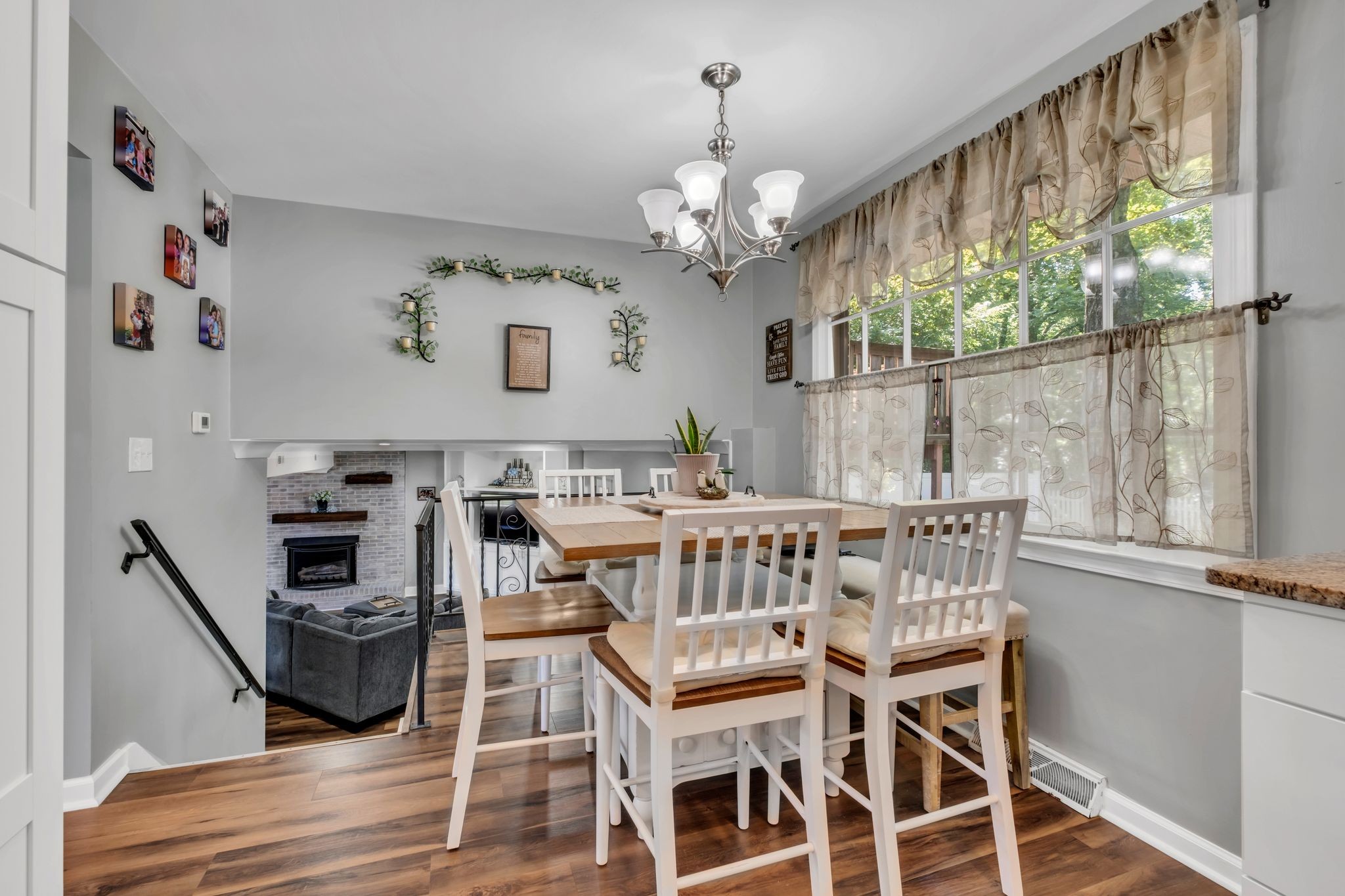 1708 Indian Hills Road Lebanon, TN 37087 - Photo 11 of 34 a view of a dining room with furniture a chandelier and wooden floor