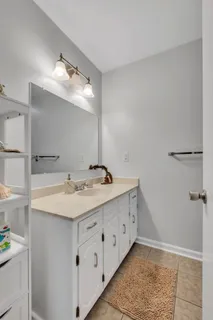 a bathroom with a double vanity sink and a mirror