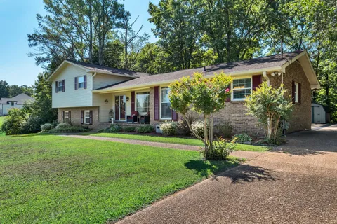 a front view of a house with a yard and porch