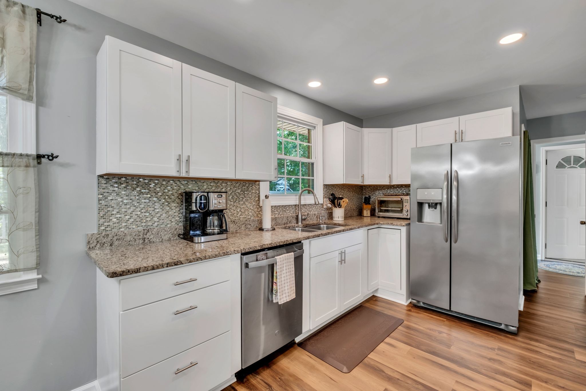 1708 Indian Hills Road Lebanon, TN 37087 - Photo 10 of 34 a kitchen with granite countertop a refrigerator sink and cabinets