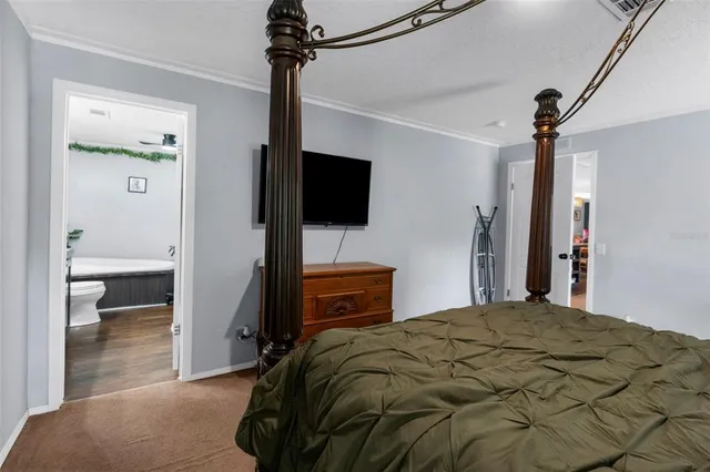 a en suite bathroom with a granite countertop sink and a mirror