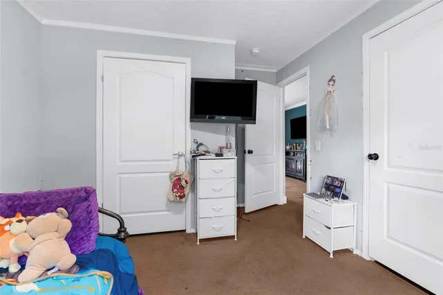 a bedroom with a bed and a potted plant