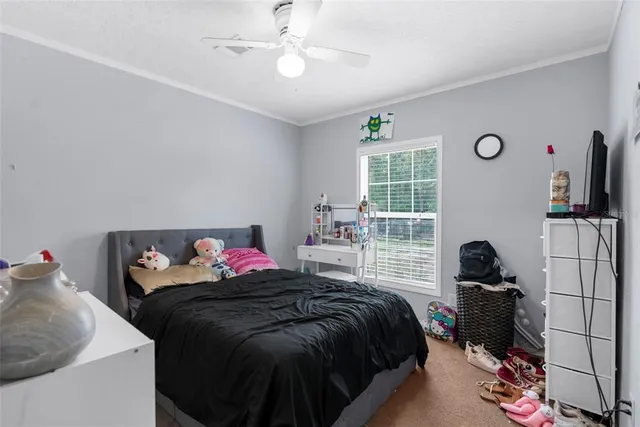 a bedroom with bed and a window