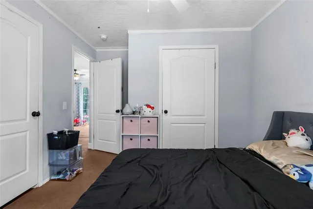 a bedroom with furniture and a flat screen tv