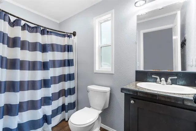 a large kitchen with stainless steel appliances kitchen island granite countertop a stove and a refrigerator