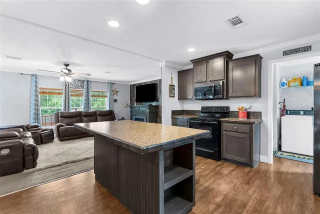 a kitchen with stainless steel appliances granite countertop a sink stove and cabinets