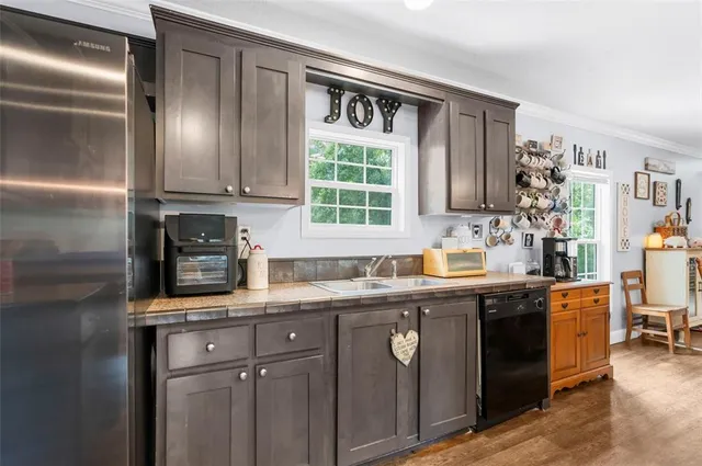 a kitchen with stainless steel appliances granite countertop a stove refrigerator sink and microwave