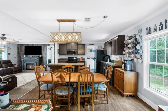 a front view of house with yard and trees all around