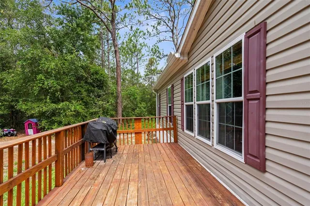 a view of a house with a yard and furniture