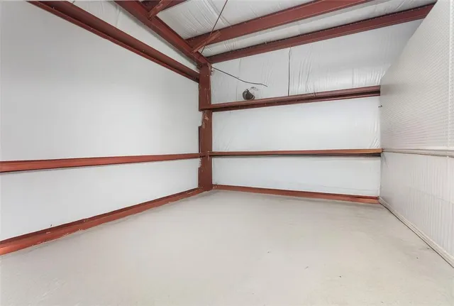 a kitchen with white cabinets and sink