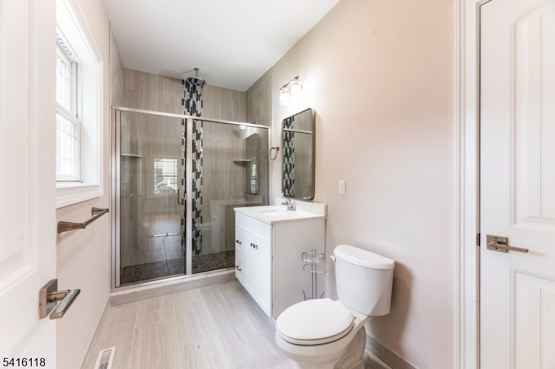 118 Cambridge Road Westfield, NJ 07090 - Photo 21 of 50 a white toilet sitting next to a bathroom sink