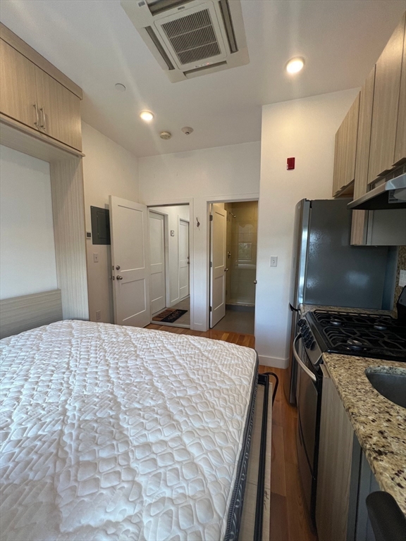 21 5th Street, Unit 26 Chelsea, MA 02150 - Photo 7 of 11 a kitchen with stainless steel appliances a refrigerator and a stove top oven