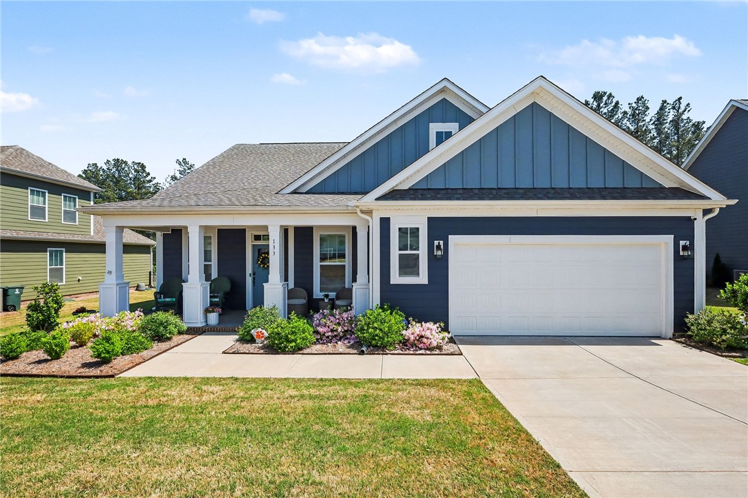 This charming residence features a welcoming front porch and a well-maintained lawn.