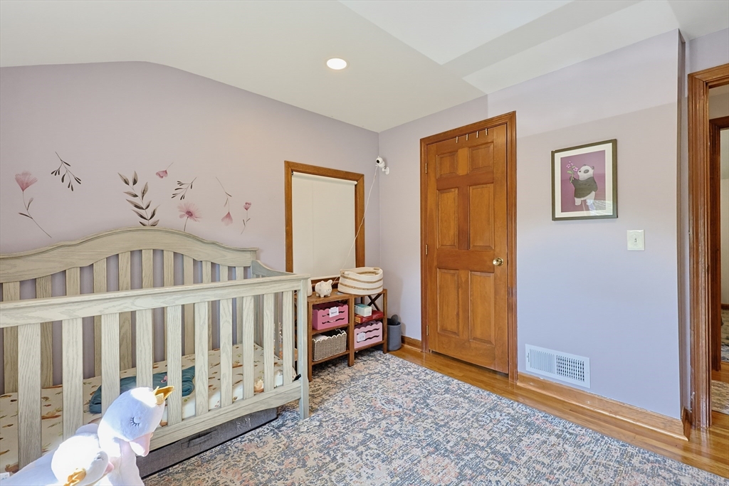 19 Weir Road Waltham, MA 02451 - Photo 33 of 41 a bedroom with a wooden floor and a window