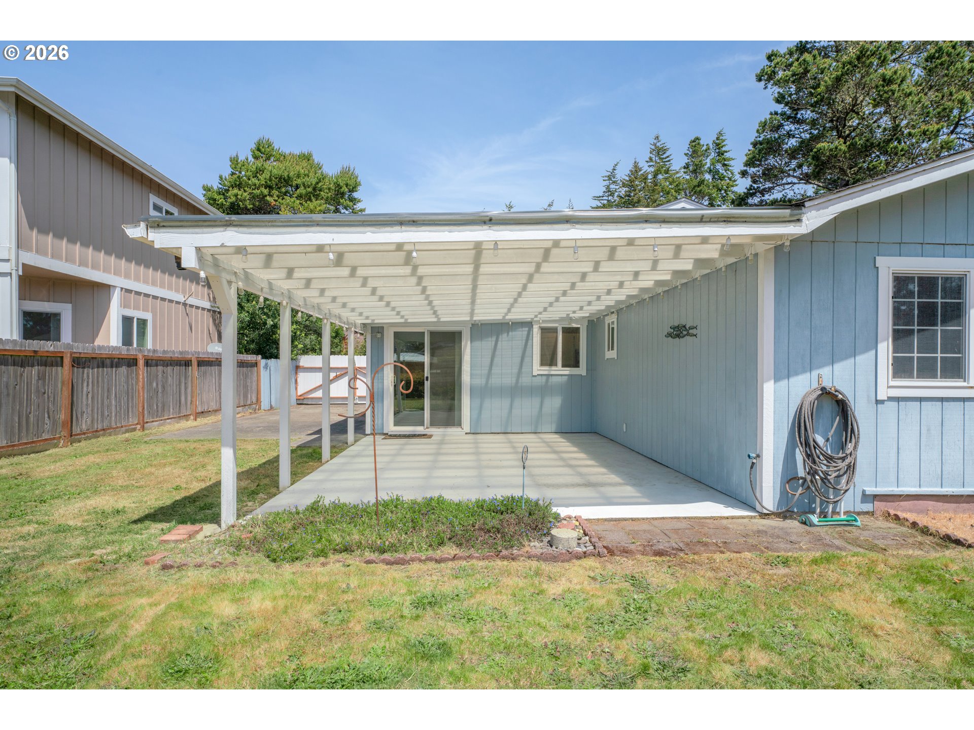 1142 9th Street Florence, OR 97439 - Photo 31 of 41 a view of a backyard with a patio