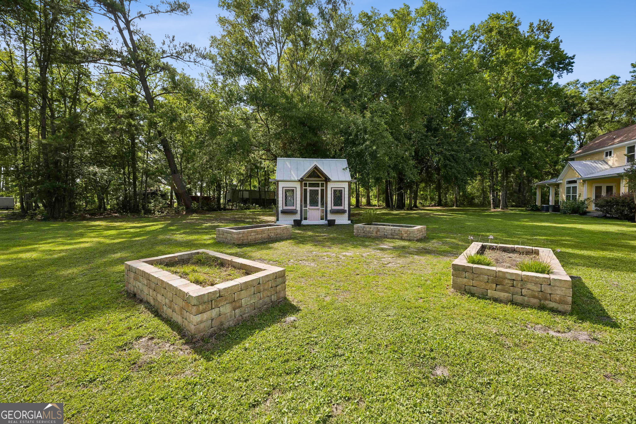 706 Hopewell Point Road White Oak, GA 31568 - Photo 78 of 84 A charming garden cottage is surrounded by raised planting beds, creating the perfect space for gardening, hobbies, or creative projects.