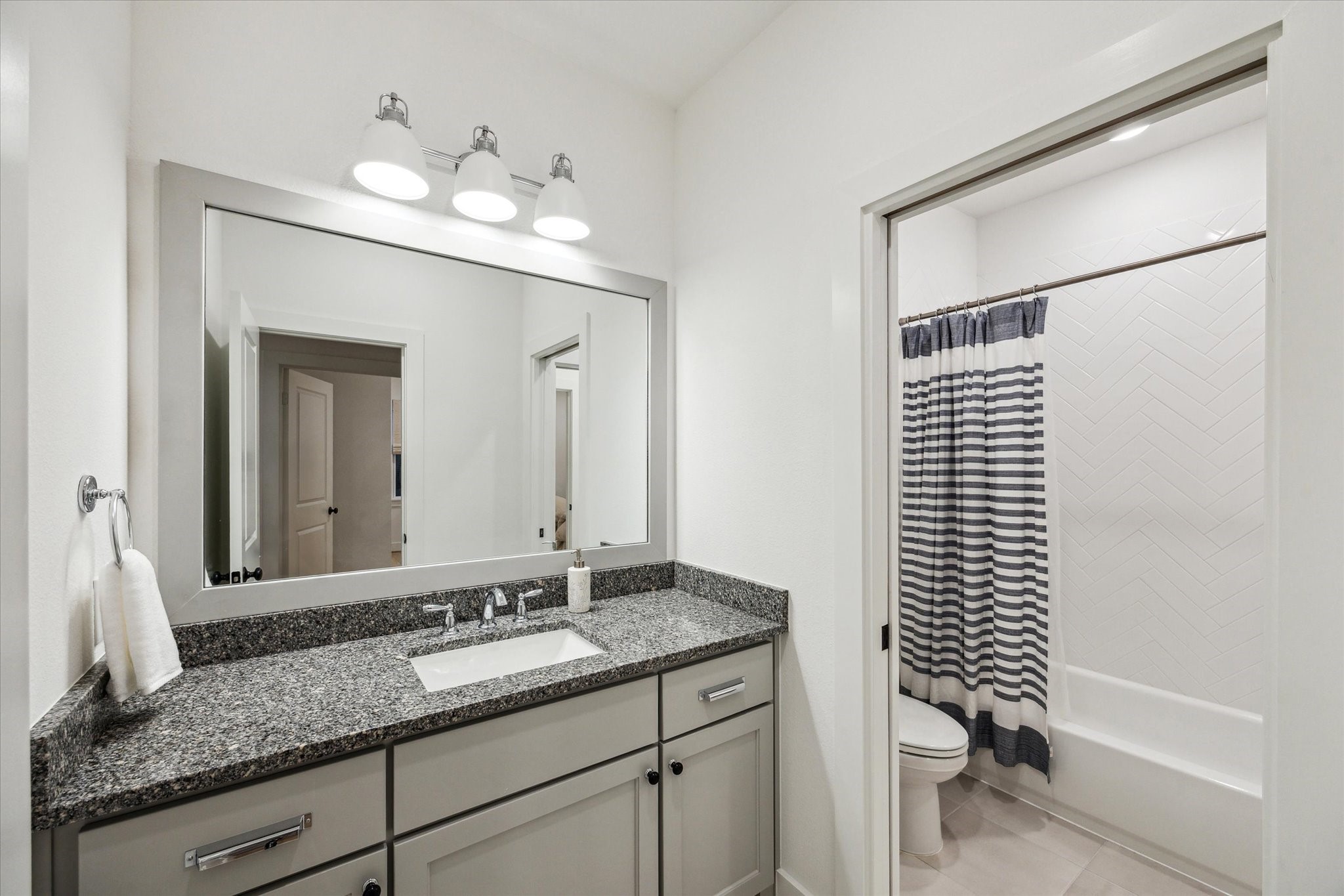 13167 Fm 389 Road Burton, TX 77835 - Photo 32 of 49 a bathroom with a granite countertop sink a toilet and mirror