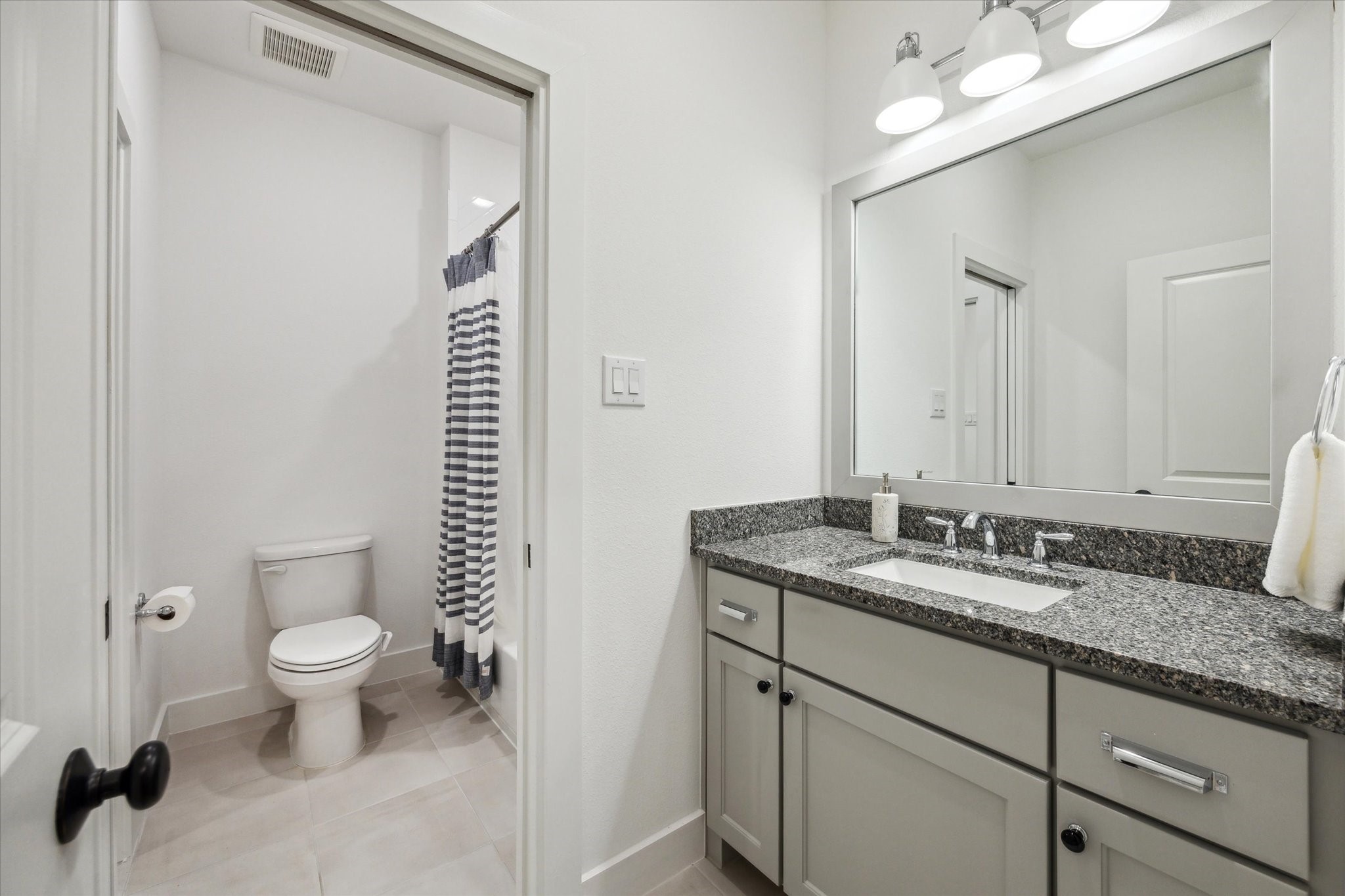 13167 Fm 389 Road Burton, TX 77835 - Photo 33 of 49 a bathroom with a granite countertop sink a toilet and a mirror