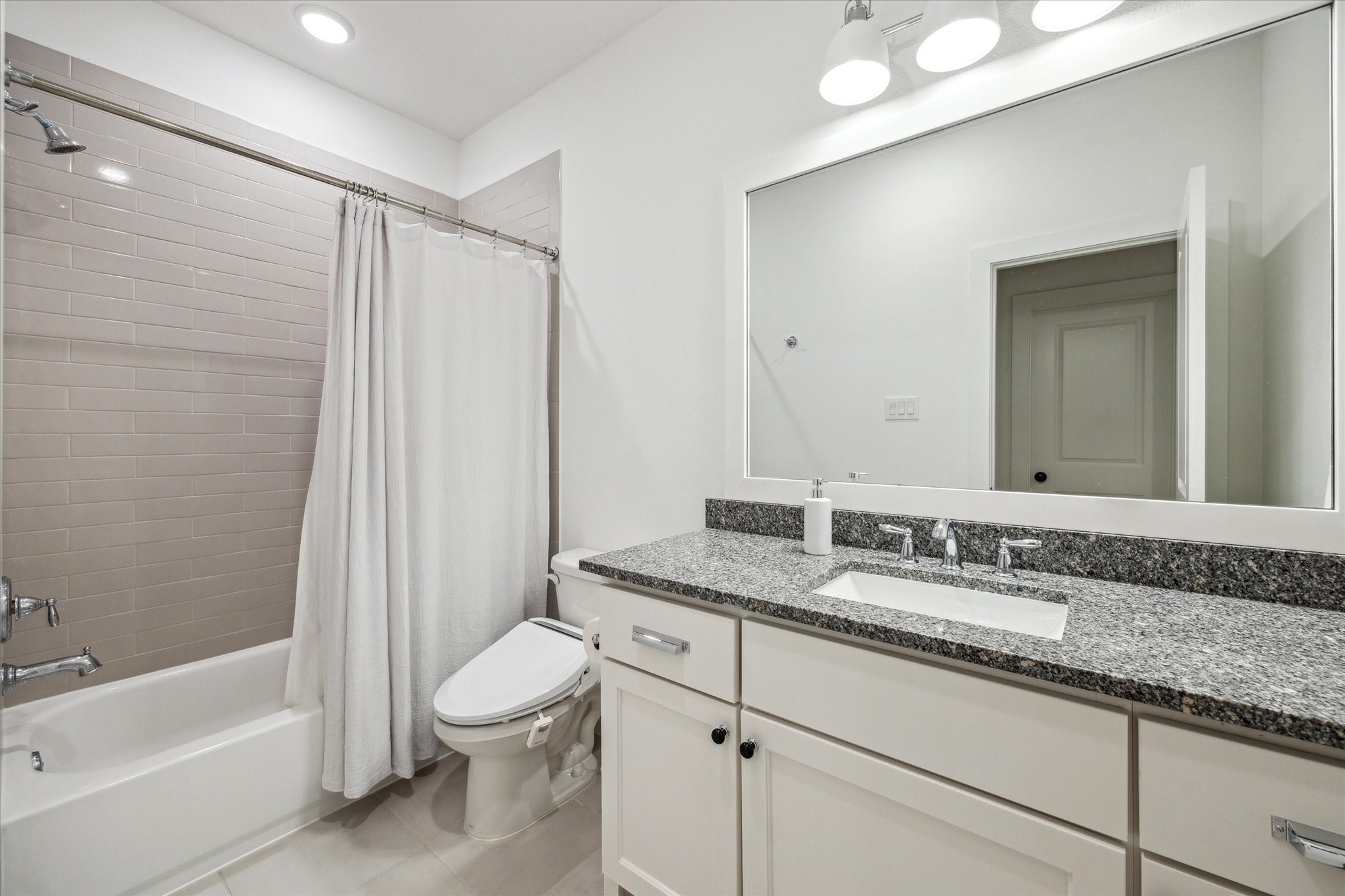13167 Fm 389 Road Burton, TX 77835 - Photo 36 of 49 a bathroom with a granite countertop sink a toilet and shower
