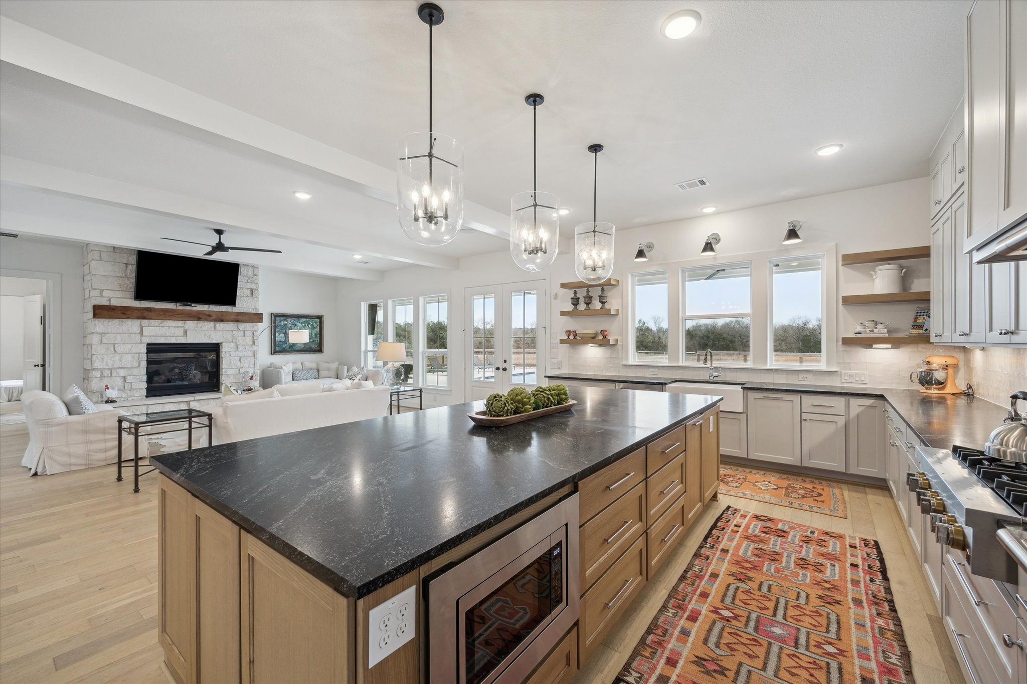 13167 Fm 389 Road Burton, TX 77835 - Photo 10 of 49 a large kitchen with stainless steel appliances granite countertop a sink a stove and a wooden floors