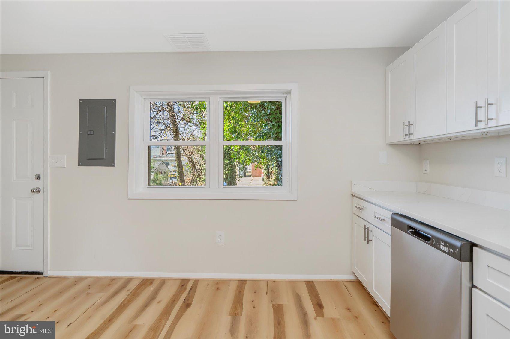 4322 Annapolis Road Baltimore, MD 21227 - Photo 13 of 28 a view of a kitchen with wooden floor and electronic appliances