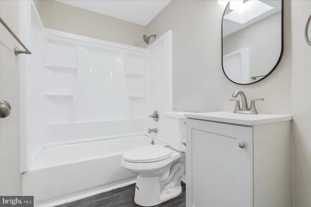 a bathroom with a sink a toilet and a mirror