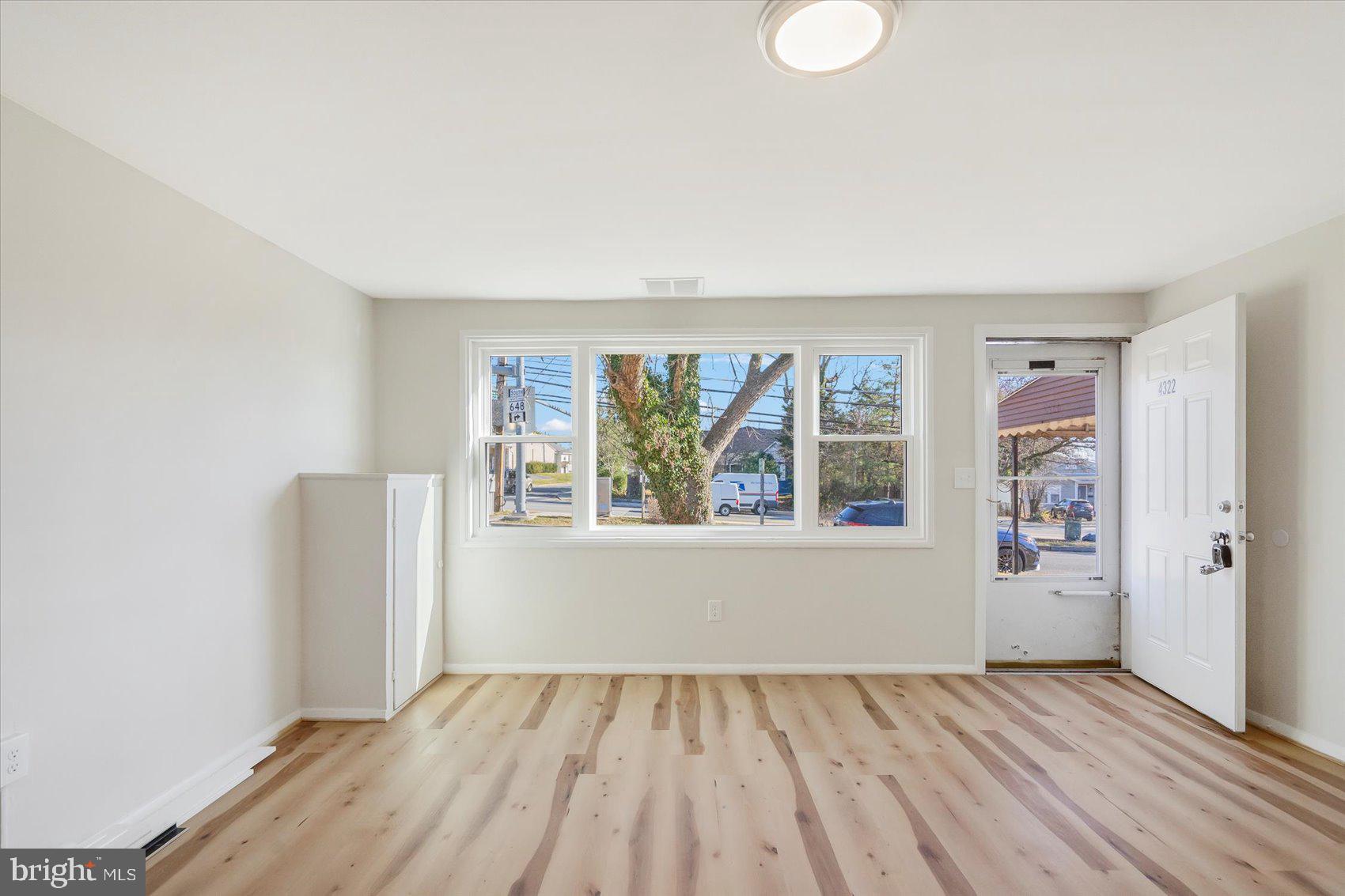4322 Annapolis Road Baltimore, MD 21227 - Photo 5 of 28 wooden floor in an empty room with a window