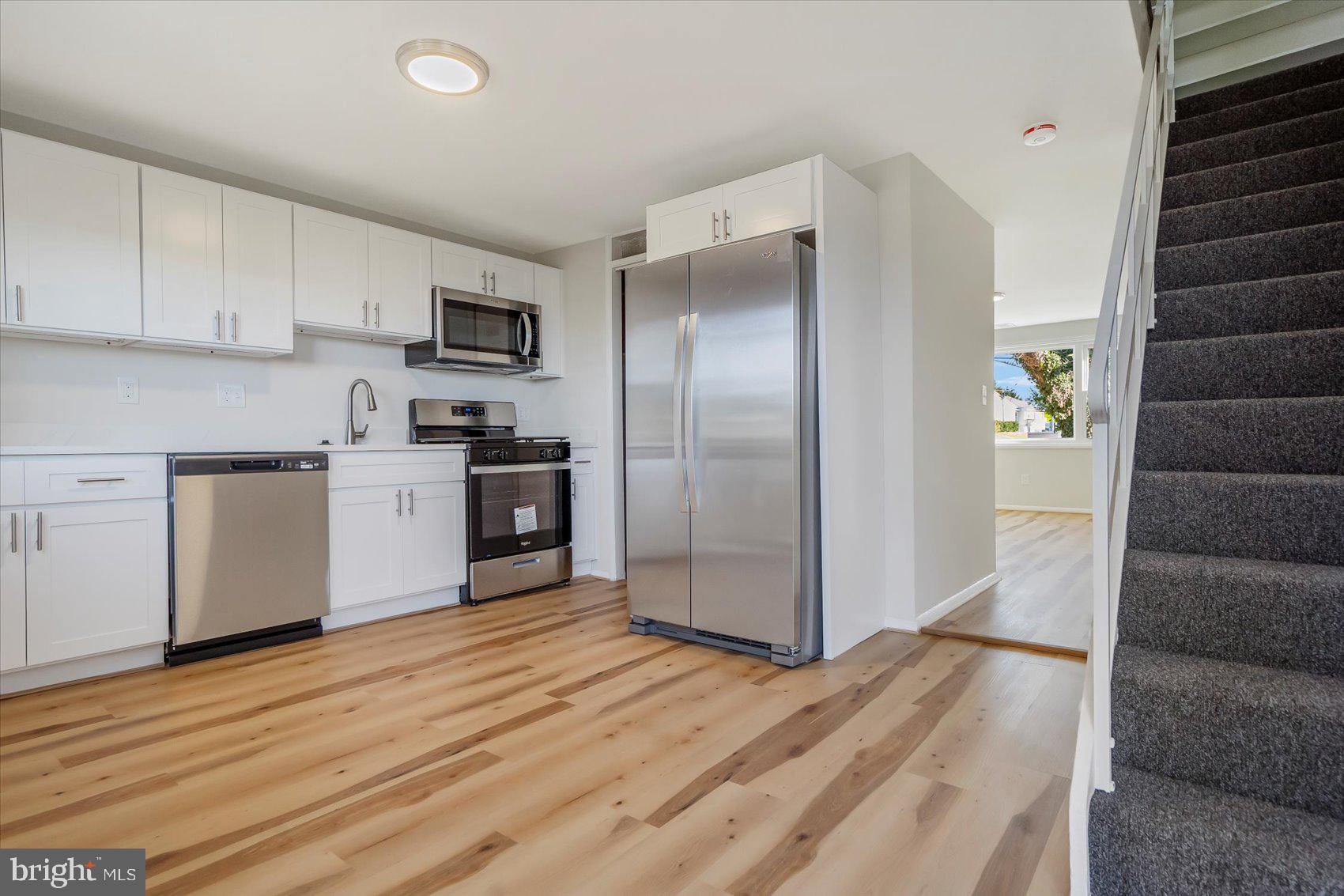 4322 Annapolis Road Baltimore, MD 21227 - Photo 9 of 28 a kitchen with stainless steel appliances granite countertop a refrigerator and a stove top oven