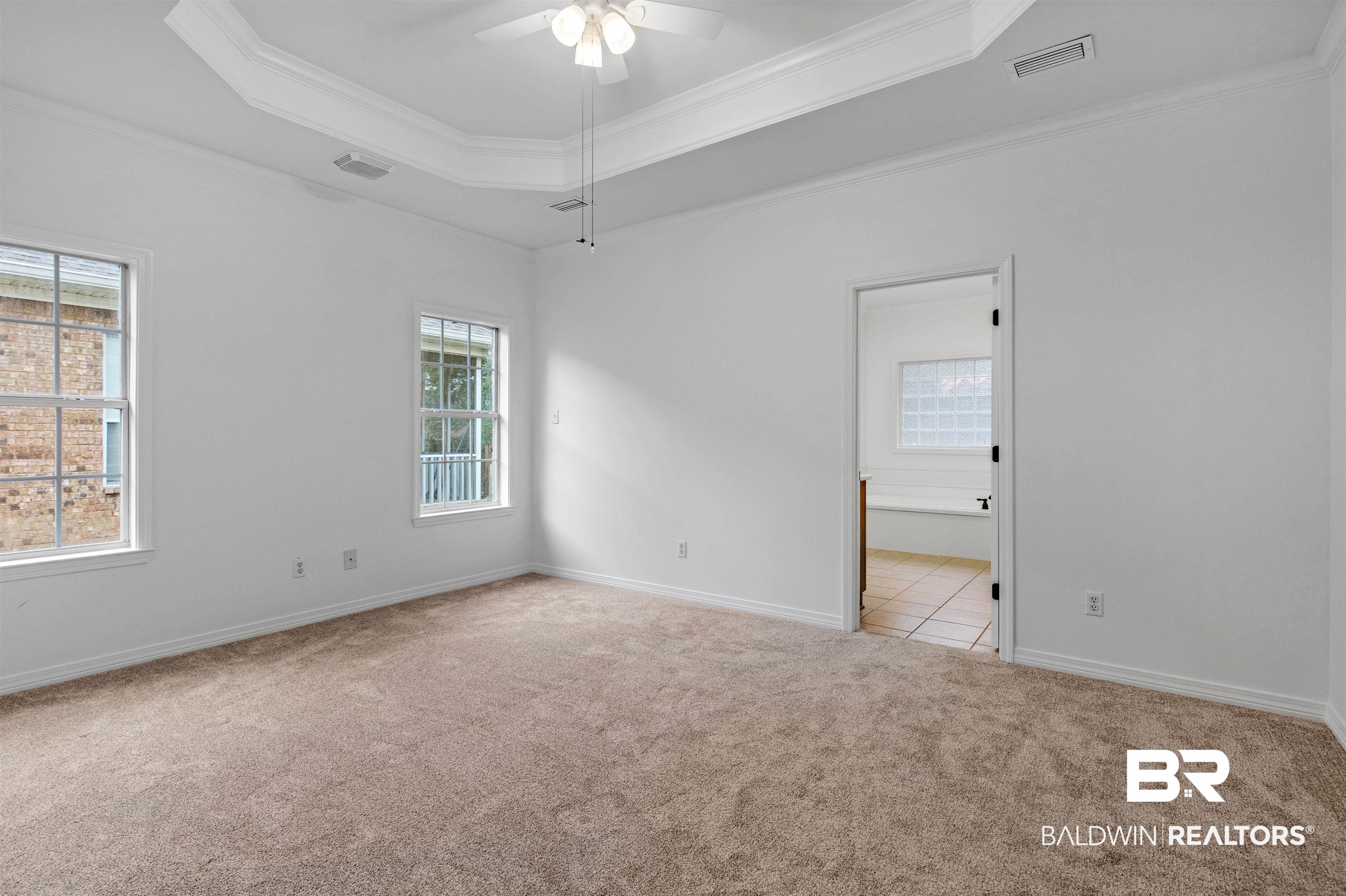 1007 Linlen Avenue Mobile, AL 36609 - Photo 15 of 21 Spare room with a tray ceiling, light carpet, ceiling fan, and crown molding
