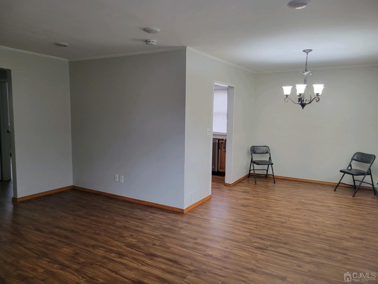 420 Cross Road, Unit 11 Matawan, NJ 07747 - Photo 8 of 15 a view of an empty room with wooden floor and a window