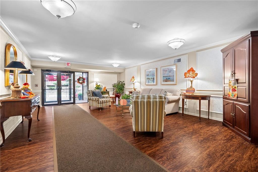1500 Cochran Road, Unit 412 Pittsburgh, PA 15243 - Photo 5 of 45 a living room with furniture a dining table and chairs with wooden floor