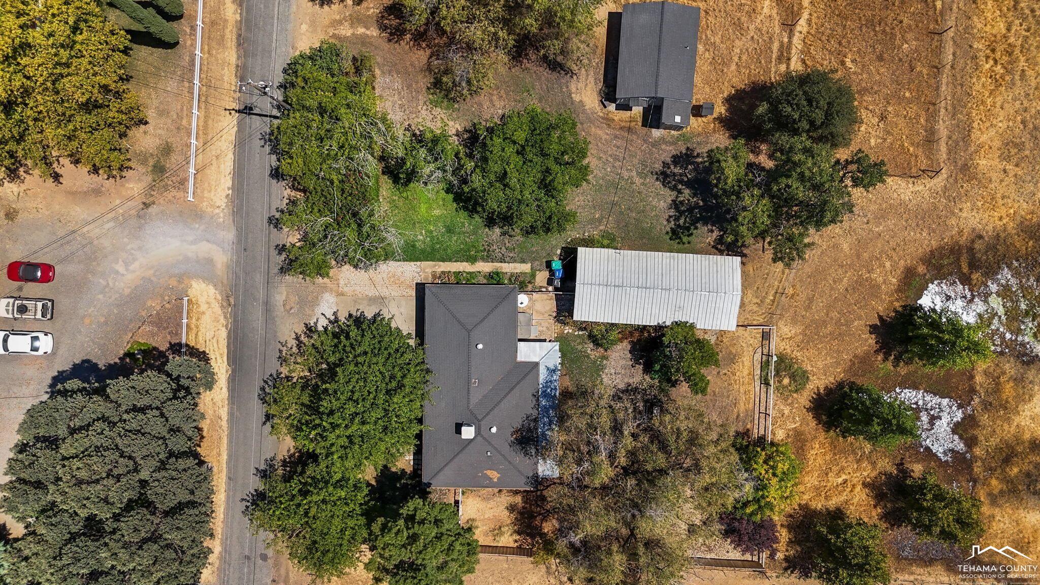 22275 Brent Road Red Bluff, CA 96080 - Photo 2 of 47 an aerial view of a house with a yard and garden