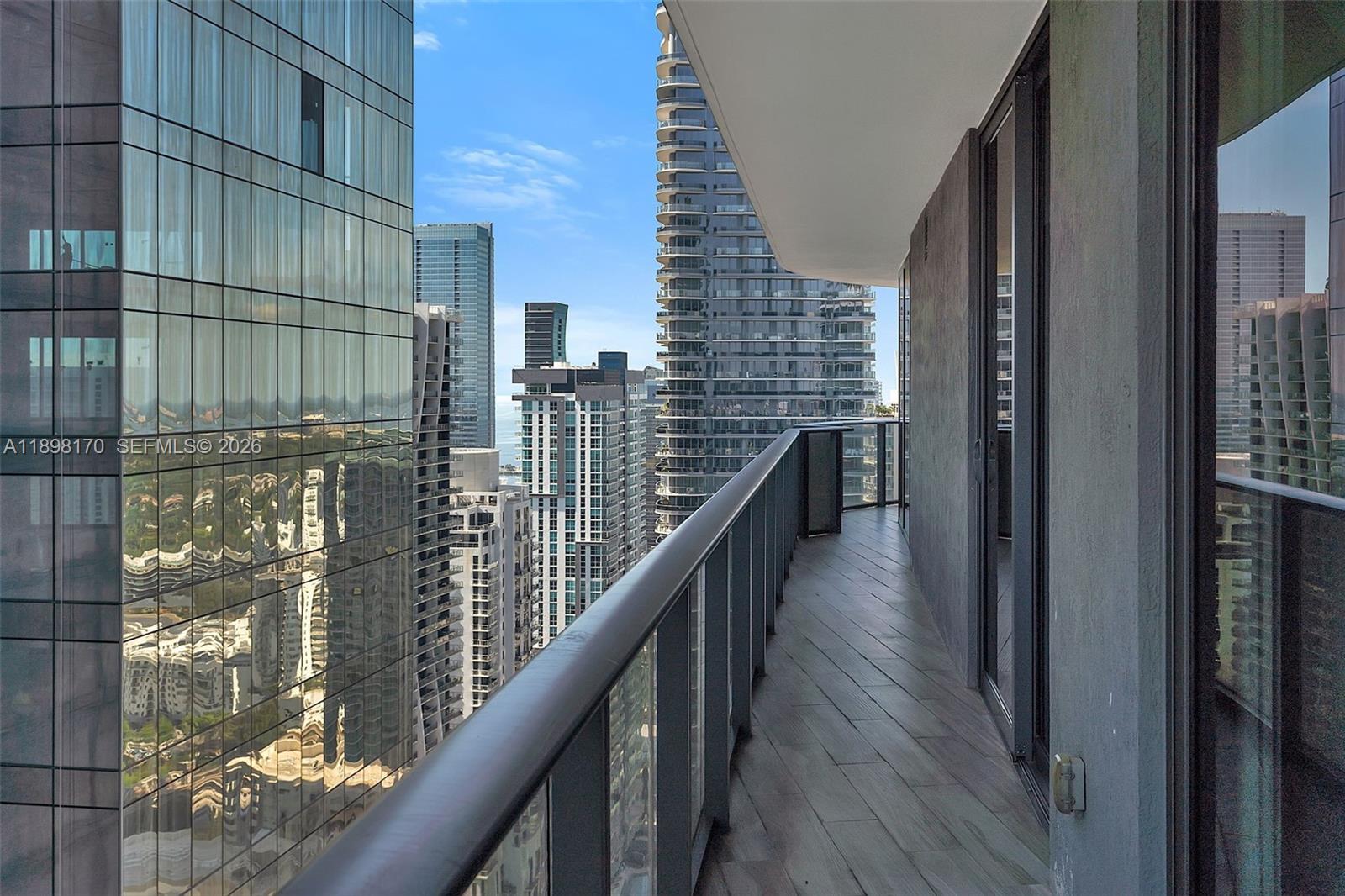 801 South Miami Avenue, Unit 4404 Miami, FL 33131 - Photo 13 of 37 a balcony with wooden floor and stairs