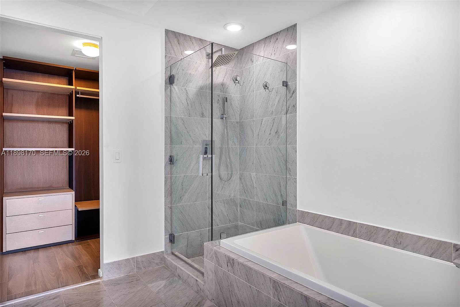 801 South Miami Avenue, Unit 4404 Miami, FL 33131 - Photo 20 of 37 a bathroom with a bathtub and a shower