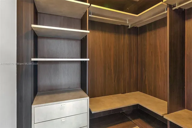 a bathroom with a tub sink vanity and mirror
