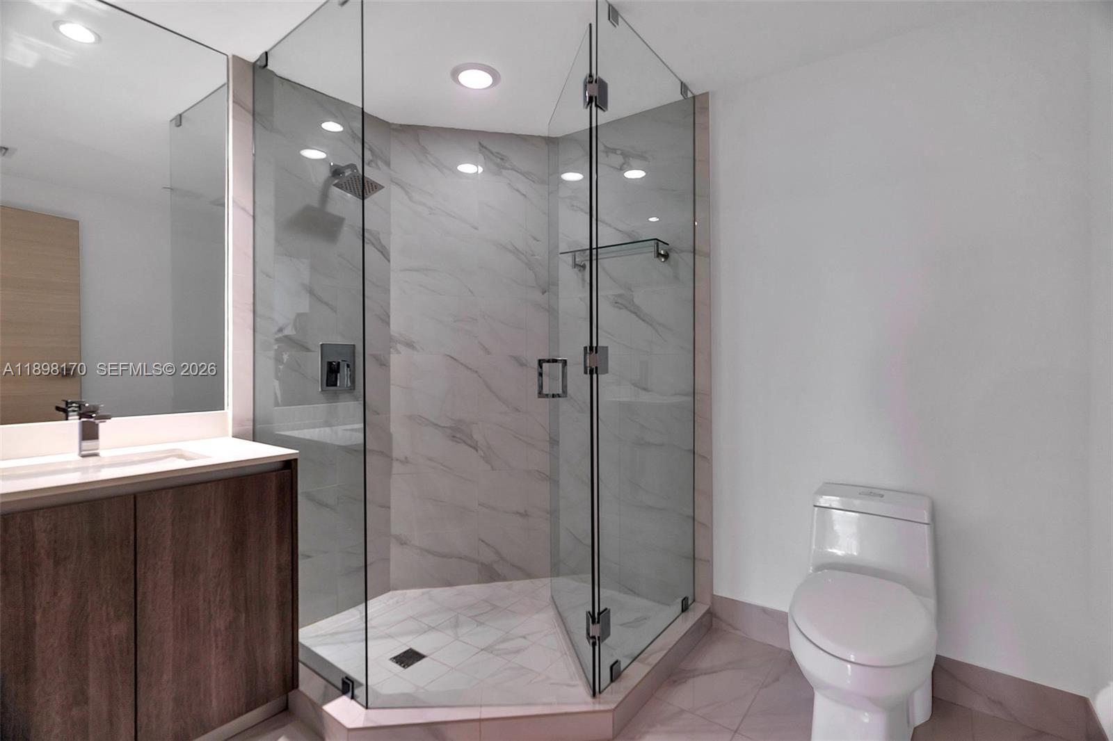 801 South Miami Avenue, Unit 4404 Miami, FL 33131 - Photo 29 of 37 a bathroom with a shower a toilet and sink