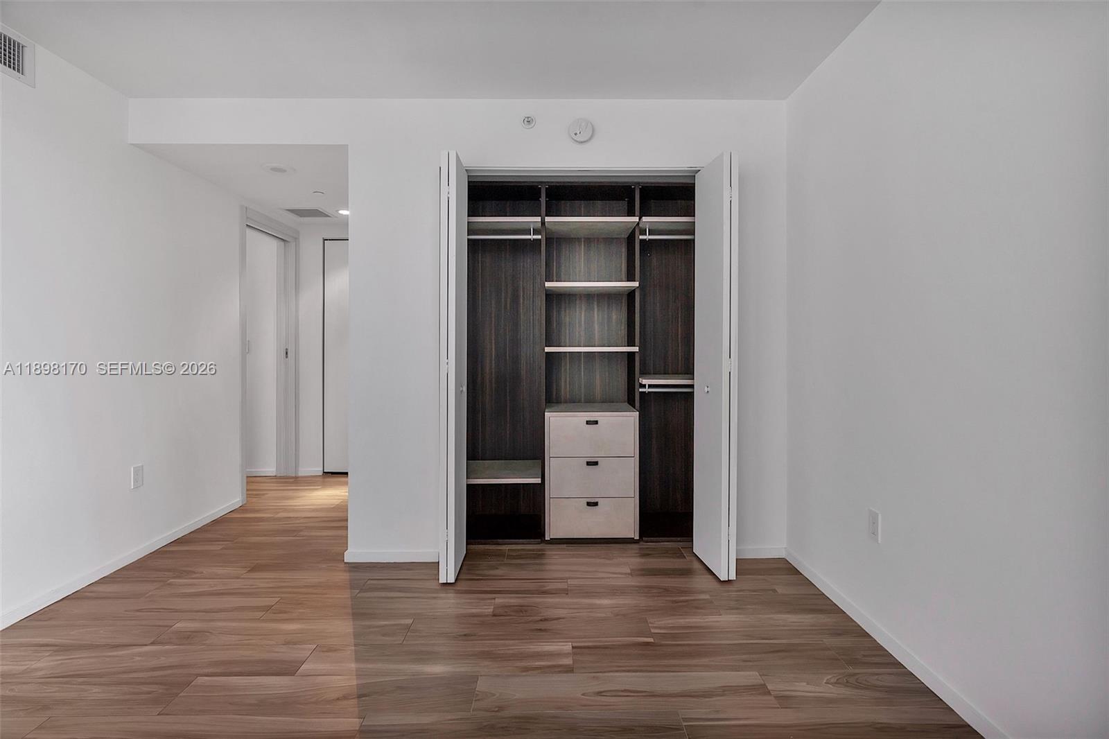 801 South Miami Avenue, Unit 4404 Miami, FL 33131 - Photo 31 of 37 wooden floor and cabinet in a room