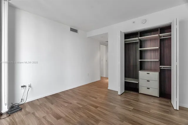 a room with walk in closet and window